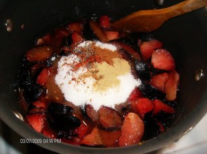 sliced plums in juice with sugar and spices